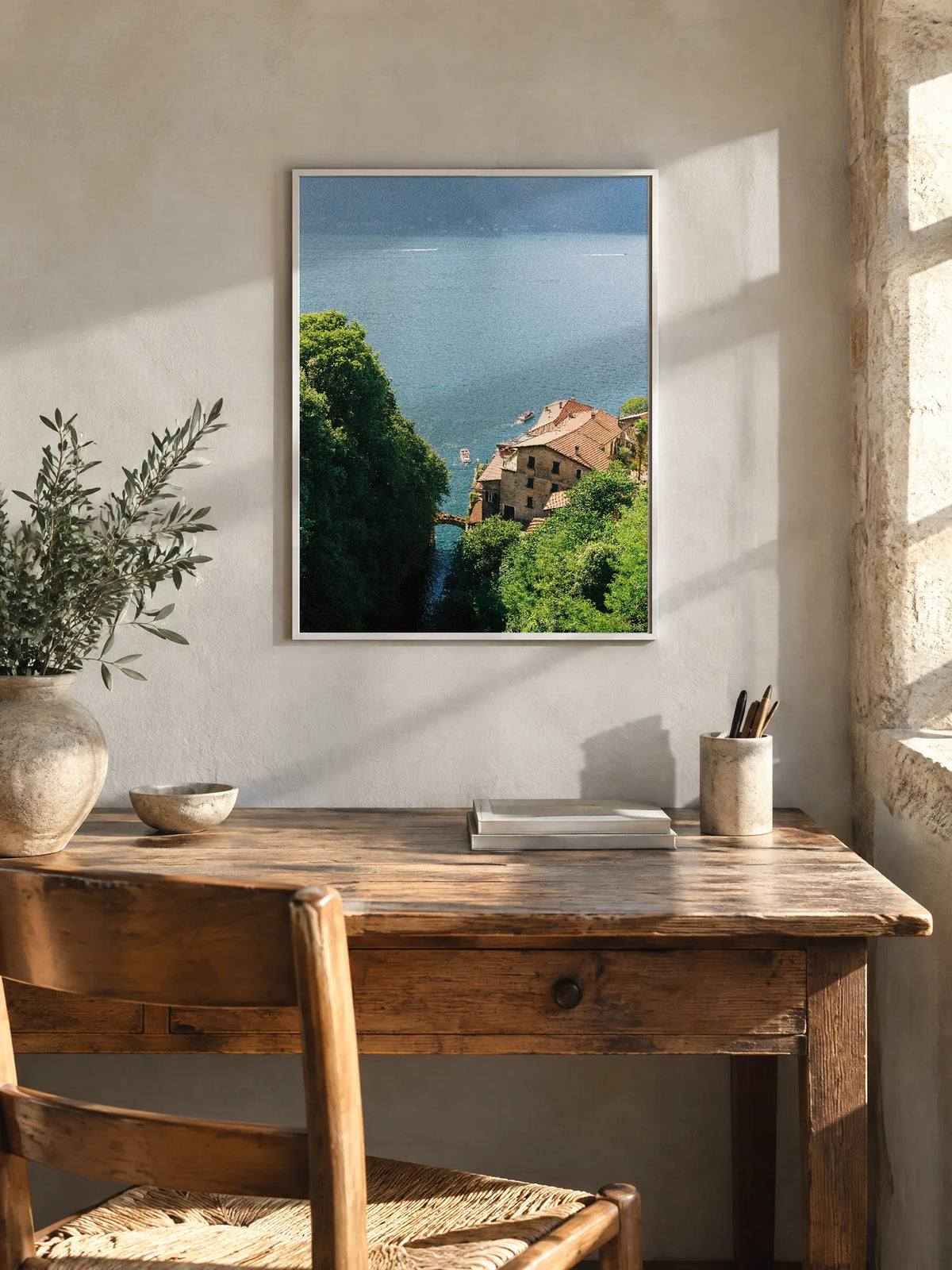 Over the Bay by Wam Ornelas, framed full bleed in white metal (18 × 24 in), above a wooden desk