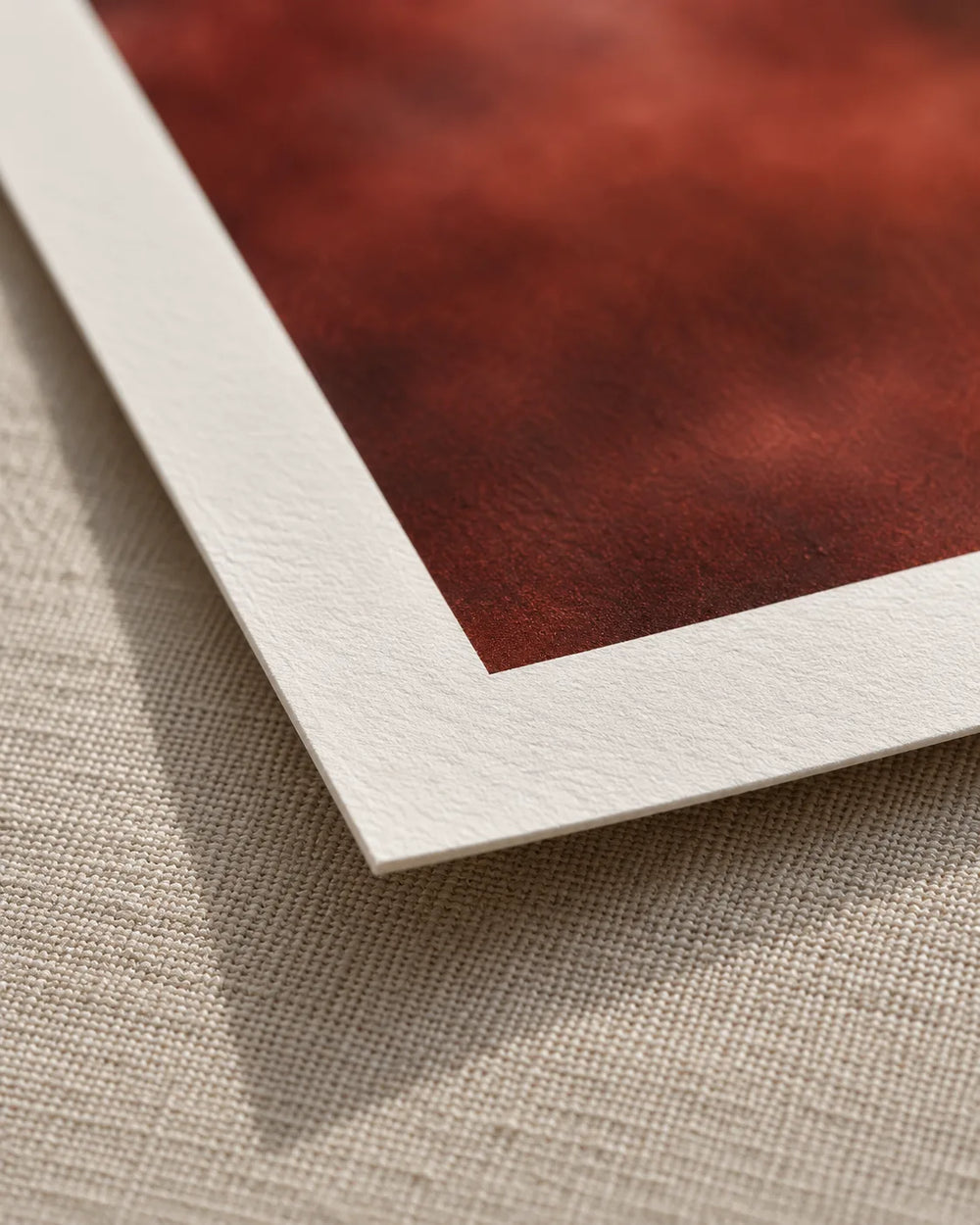 Corner of a cotton rag print: satin printed area and matt white paper margin