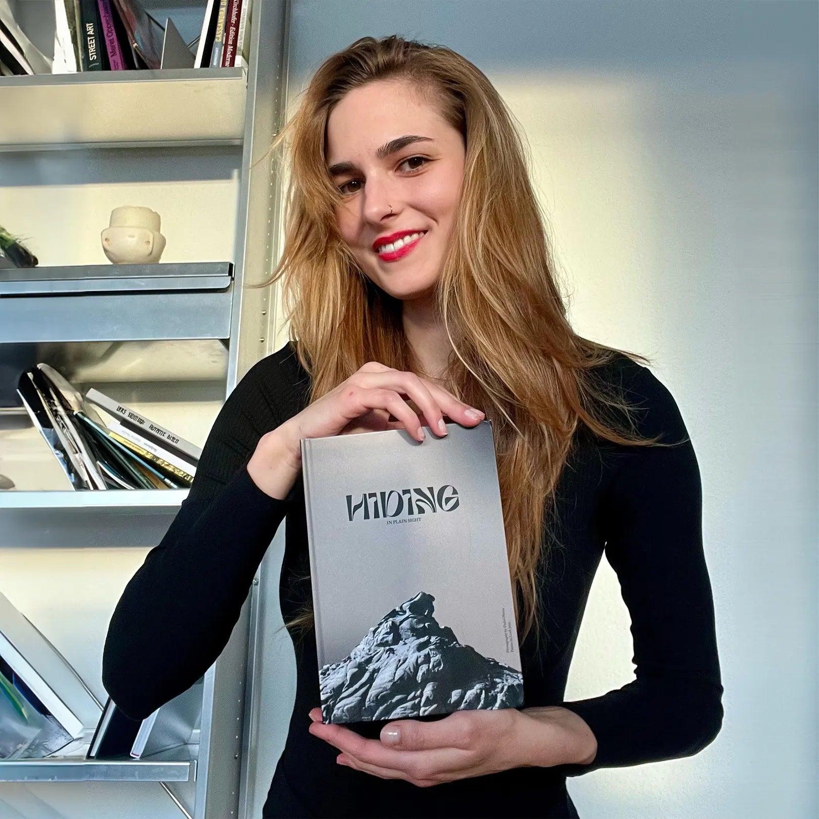 Dafni Planta Holding her Photo Book Hiding in plain sight