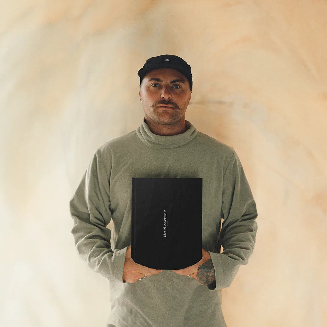 Wesley Lewis holding photo book darkwater by Wezlew