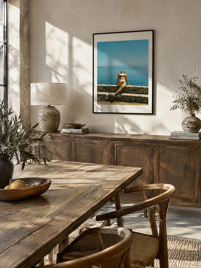 Stone Steps by Wam Ornelas, framed in black metal with a white mat (18 × 24 in), above a sideboard in a dining room
