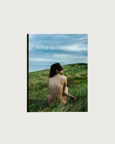 Book titled 'Poem of the Body' with a person sitting in a grassy field on the cover.